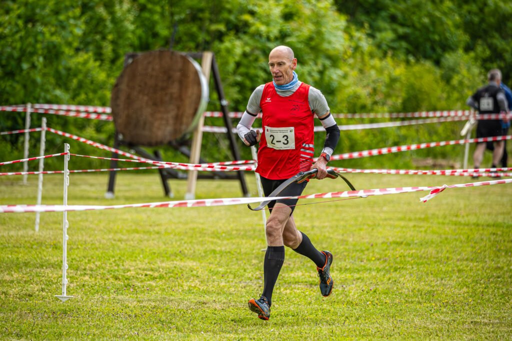Läufer mit Bogen in der Hand auf der Laufrunde
